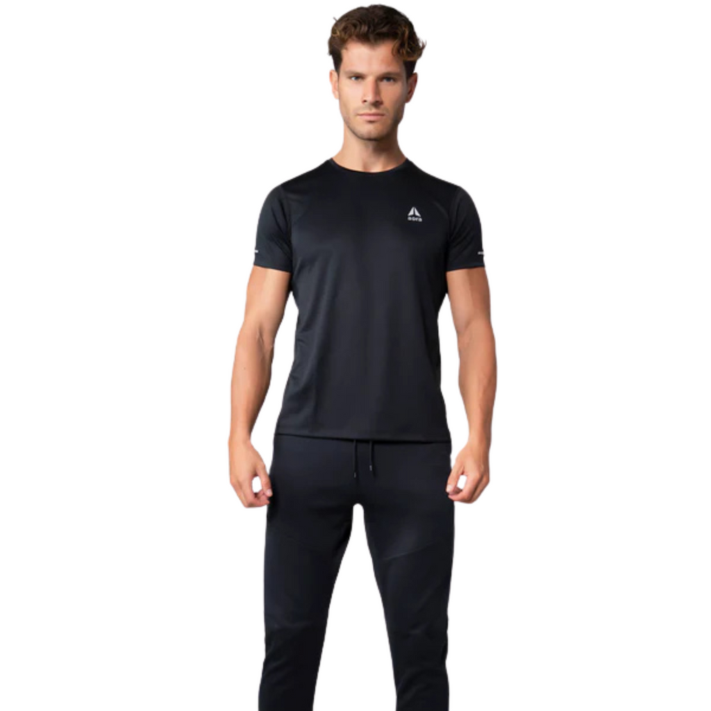 Man wearing a black athletic outfit with a brand logo on a white background